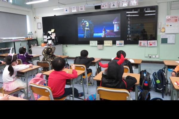 Students are watching the Halloween video attentively.