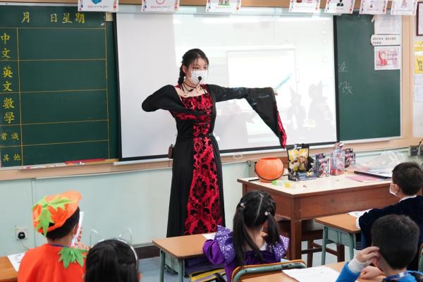 Teachers are doing different body gestures in the guessing game.