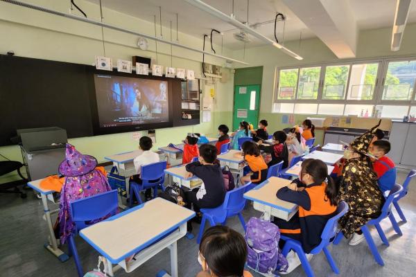 Students are paying attention to watch the Halloween video.